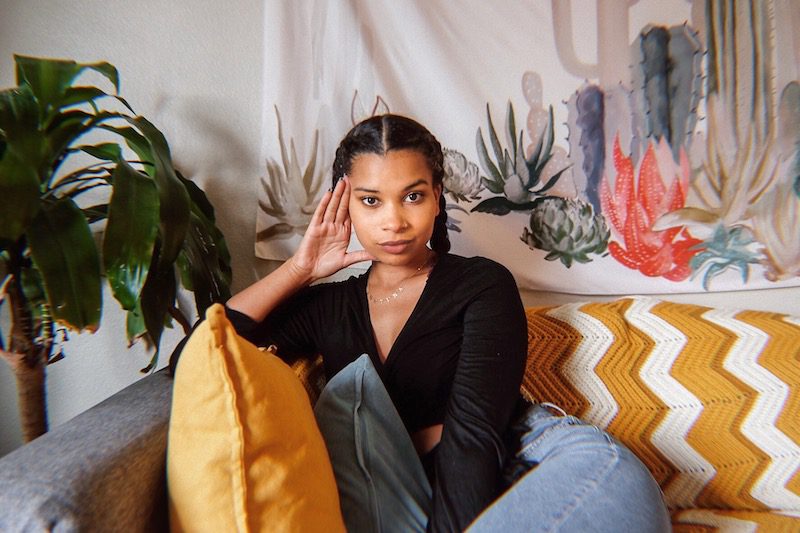 Lifestyle content creator Justina Sharp, also known by co-hosts Merk and Nyge as the "expert" of bestie break ups looks at the camera while sitting on a couch. Through a phone call, she gives them and listeners advice on how to deal with friendship fallouts.