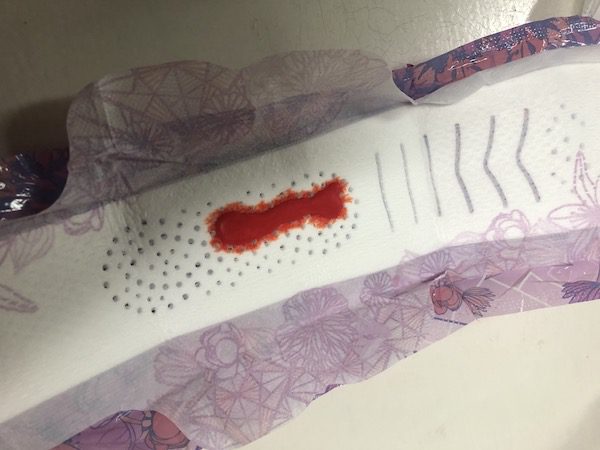 For the sake of empathizing with people who bleed, Nyge concocts a blood-like recipe (thanks to Yes Queen's Daysha Veronica) and syncs cycle with Merk for a week. Pictured is one of Nyge's pads with fake blood on one of his and Merk's lighter flow days.