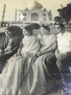 The writer's grandmother's sister, her grandmother, her great-grandma and her great-grandfather sit in front of the Taj Mahal in India with their hands in their laps.