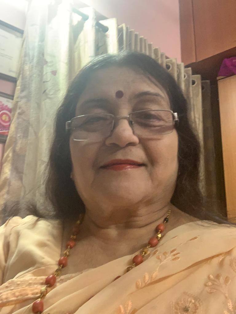The writer's grandmother, mamama, smiles for a selfie while wearing a saree.